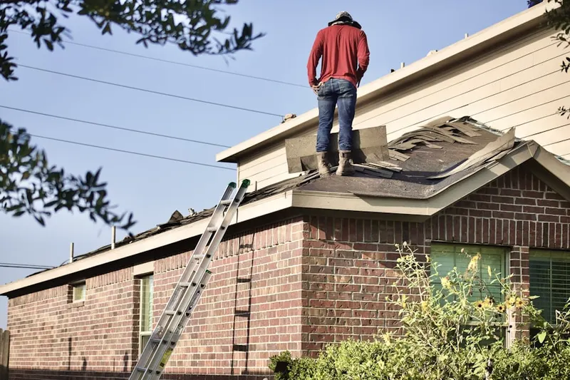 Professional roofer working on a residential roof in Chesterfield Estates